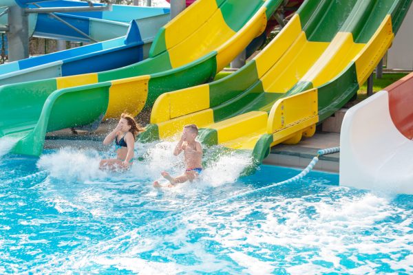 boy-and-girl-ride-with-a-water-slide-in-the-water-2026-03-26-06-04-03-utc